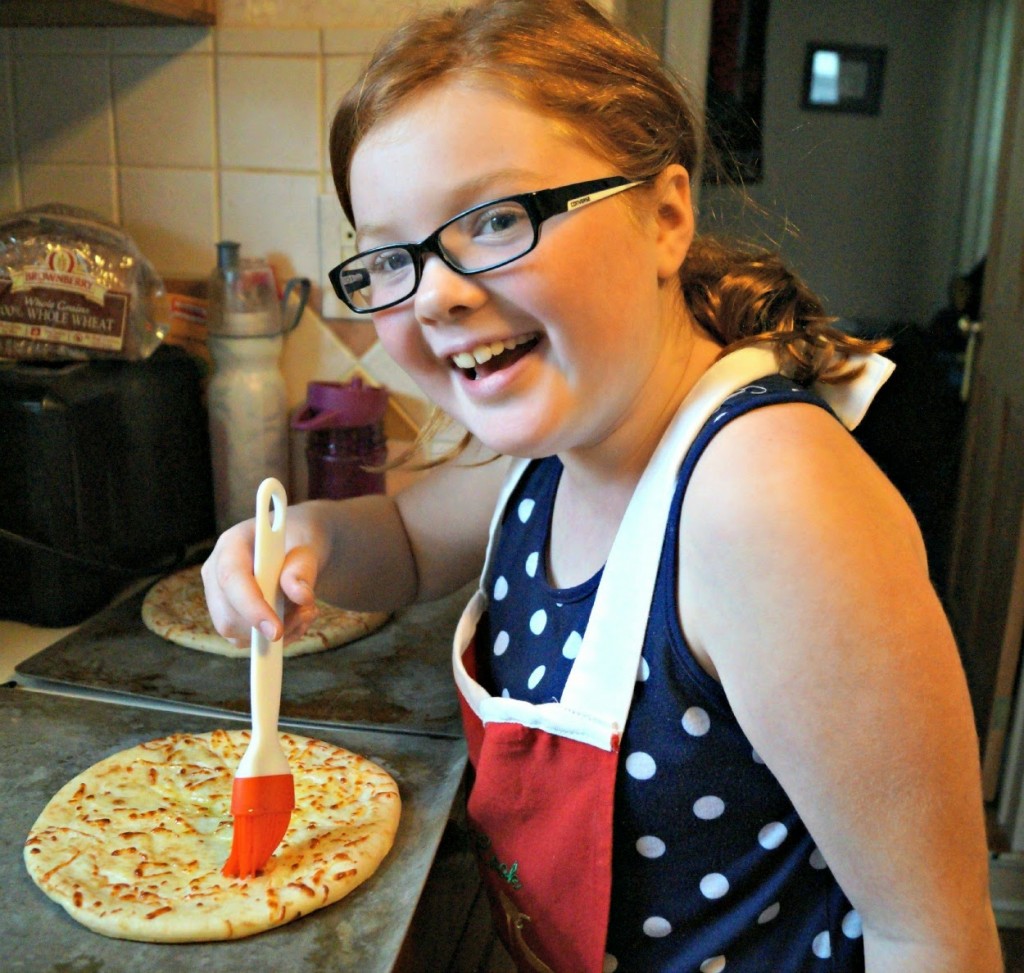 Spreading olive oil to make homemade pizza crust crispy